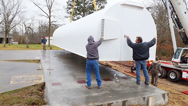 Quonset shelter set by crane